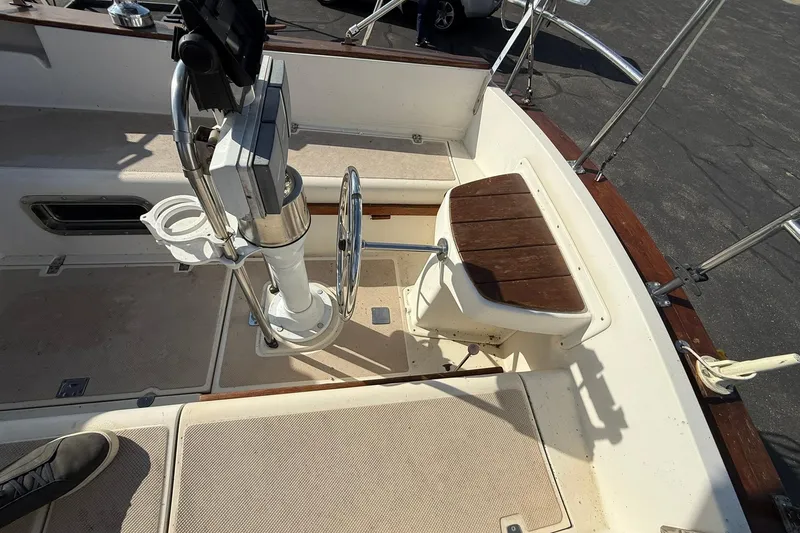 Slide: The Image of Cockpit of 1988 Island Packet 27 sailboat with steering wheel and seating. - 39
