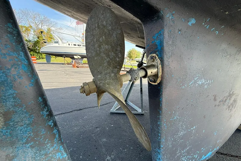 Slide: The Image of Propeller of a 1988 Island Packet 27 sailboat on dry dock, showing wear and patina. - 5