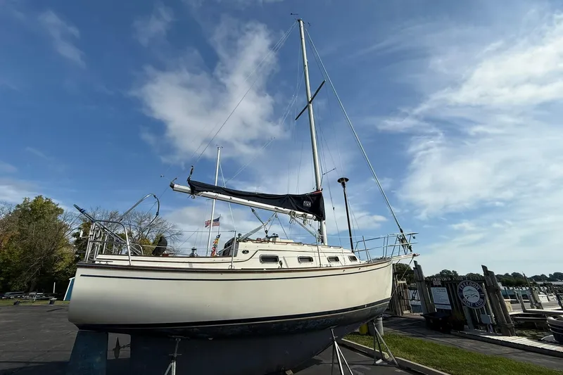 Slide: The Image of 1988 Island Packet 27 sailboat on land, clear sky background, marina setting. - 8