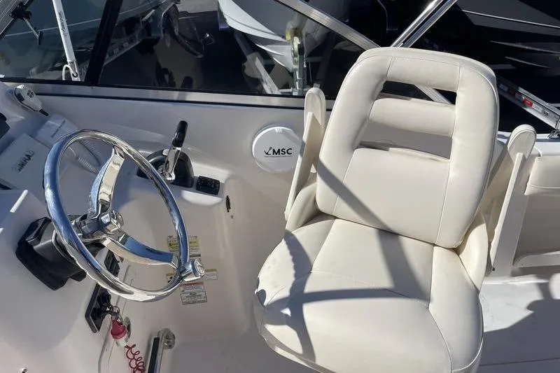 Slide: The Image of Grady-White Freedom 255 boat interior with steering wheel and white captain's chair, 2012 model. - 11