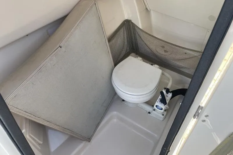 Slide: The Image of 2012 Grady-White Freedom 255 boat interior with compact marine toilet. - 12