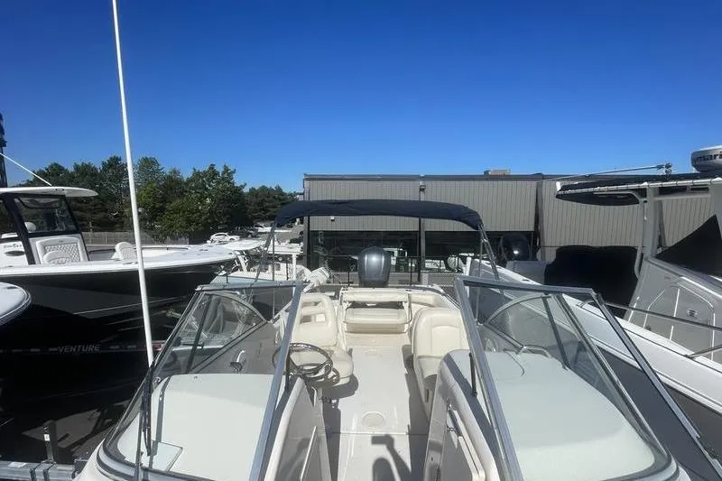 Slide: The Image of 2012 Grady-White Freedom 255 boat with open deck and canopy under clear blue sky. - 15