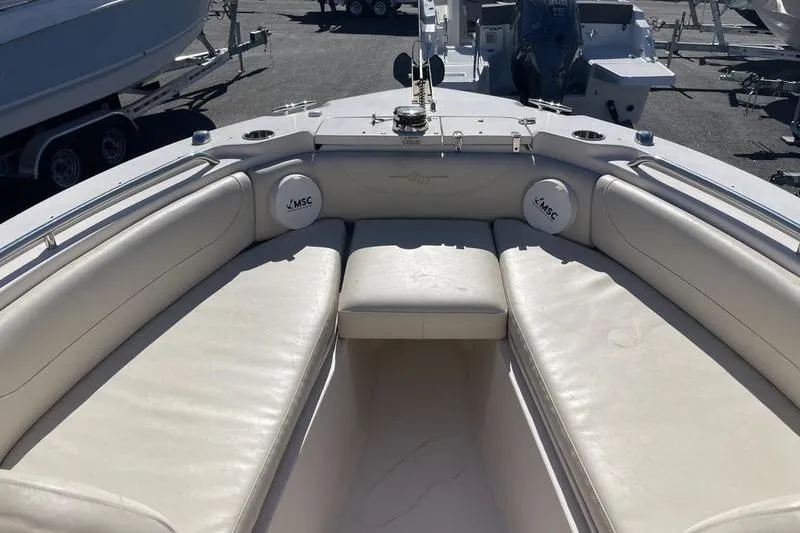 Slide: The Image of 2012 Grady-White Freedom 255 boat interior with cushioned seating and marine speakers. - 6