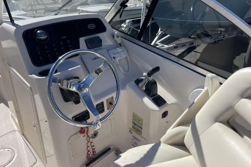 Slide: The Image of 2012 Grady-White Freedom 255 boat cockpit with steering wheel and controls. - 8