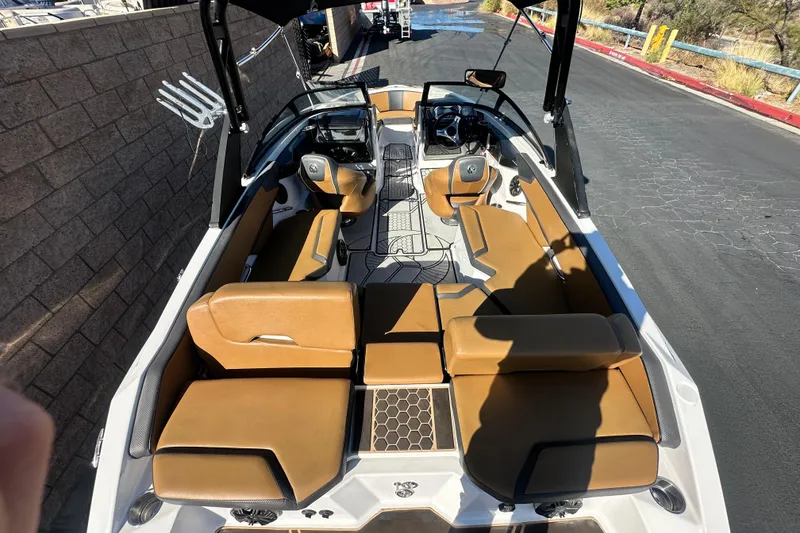 Slide: The Image of 2019 Scarab 215 Wake ID boat interior with tan seating and modern design. - 11