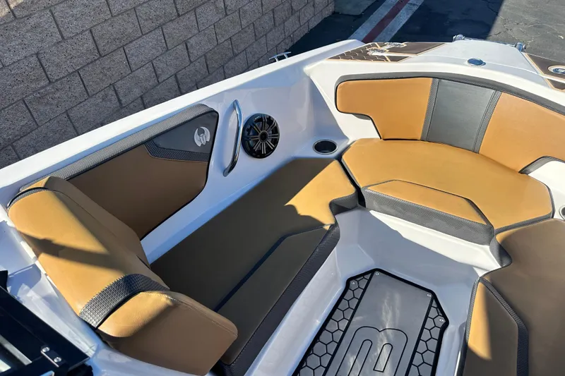 Slide: The Image of Interior of 2019 Scarab 215 Wake ID boat with tan seating and custom flooring. - 12