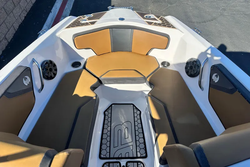 Slide: The Image of 2019 Scarab 215 Wake ID boat interior with tan and black seating. - 13