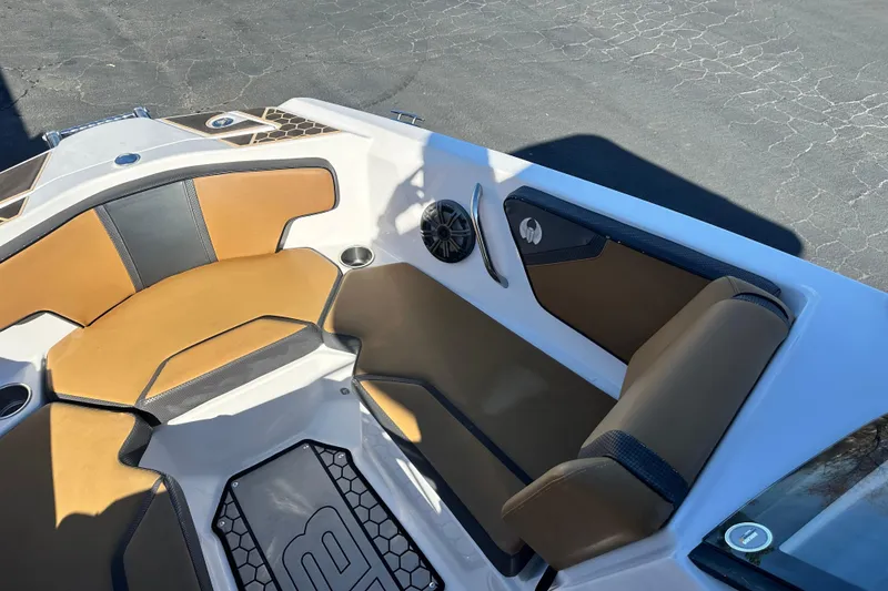 Slide: The Image of 2019 Scarab 215 Wake ID boat interior with tan and black seating, honeycomb flooring. - 14