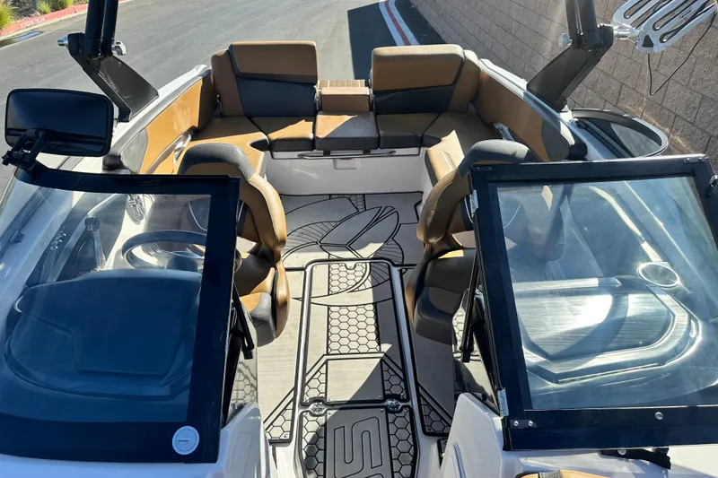 Slide: The Image of 2019 Scarab 215 Wake ID boat interior with tan and black seating, speaker, and cup holder. - 15