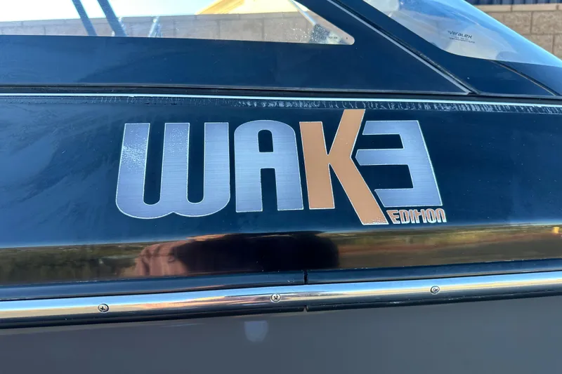 Slide: The Image of 2019 Scarab 215 Wake ID boat, rear view, showcasing seating and speakers. - 4