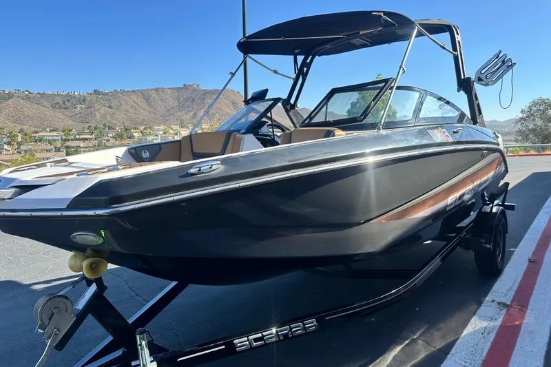 Slide: The Image of 2019 Scarab 215 Wake ID boat interior with tan seating and speakers. - 7