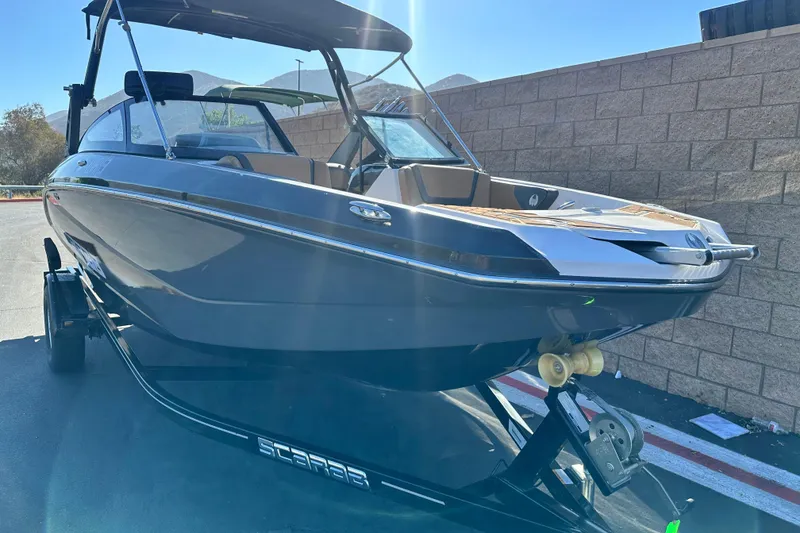 Slide: The Image of 2019 Scarab 215 Wake ID boat interior with tan and black seating. - 9