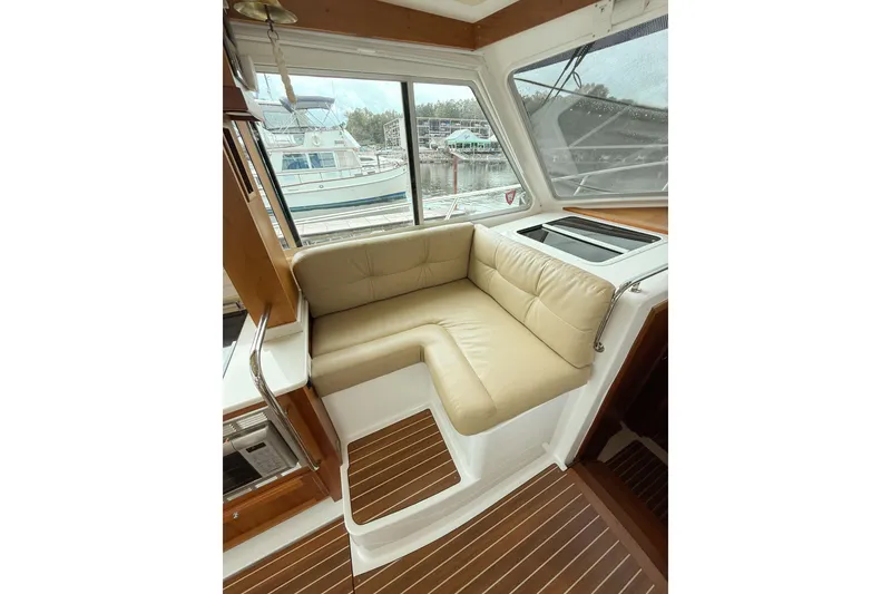 Slide: The Image of 2016 Back Cove 41 yacht interior with beige leather seating and wood flooring. - 14