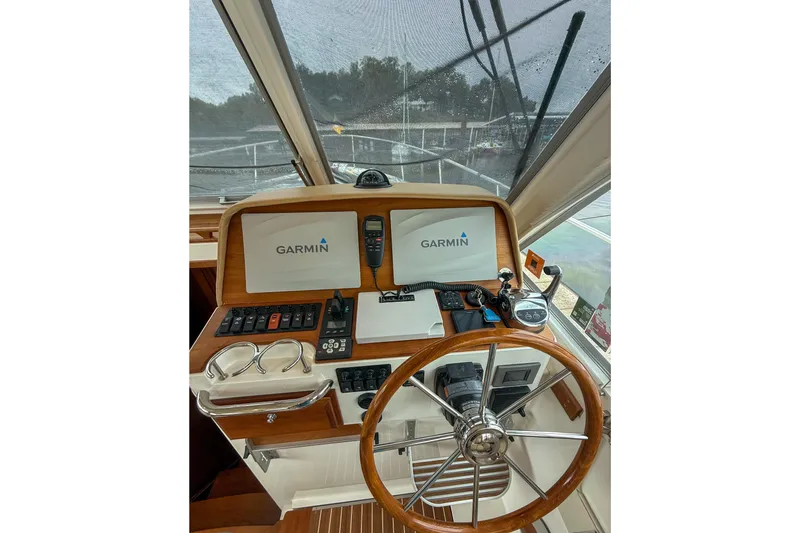 Slide: The Image of Helm of 2016 Back Cove 41 with Garmin navigation system and wooden steering wheel. - 18