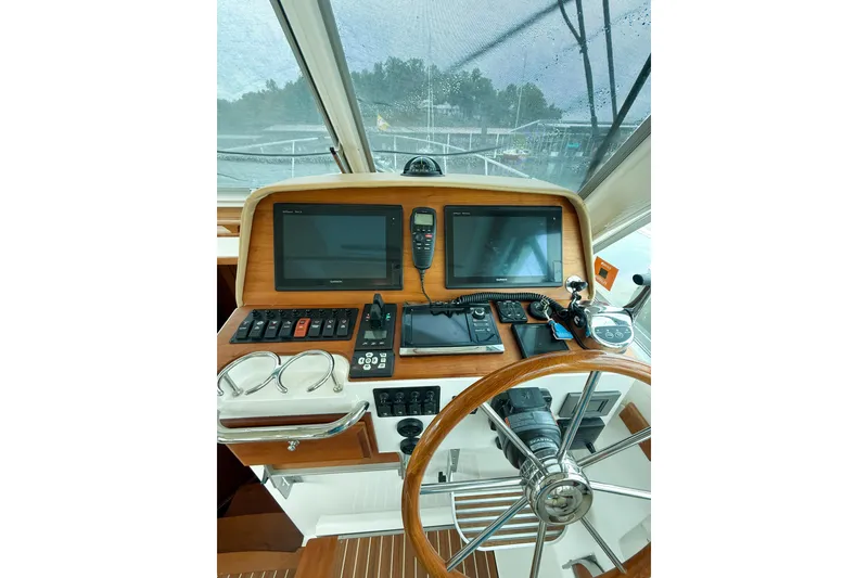 Slide: The Image of Helm of 2016 Back Cove 41 boat with navigation screens and controls. - 19