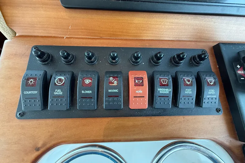 Slide: The Image of Control panel of a 2016 Back Cove 41 boat with labeled switches. - 22