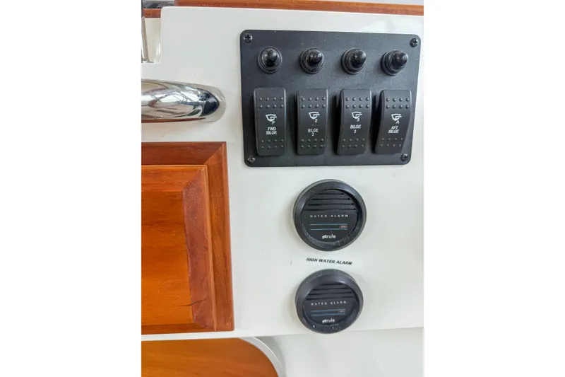 Slide: The Image of Control panel of a 2016 Back Cove 41 boat with bilge switches and water alarms. - 25