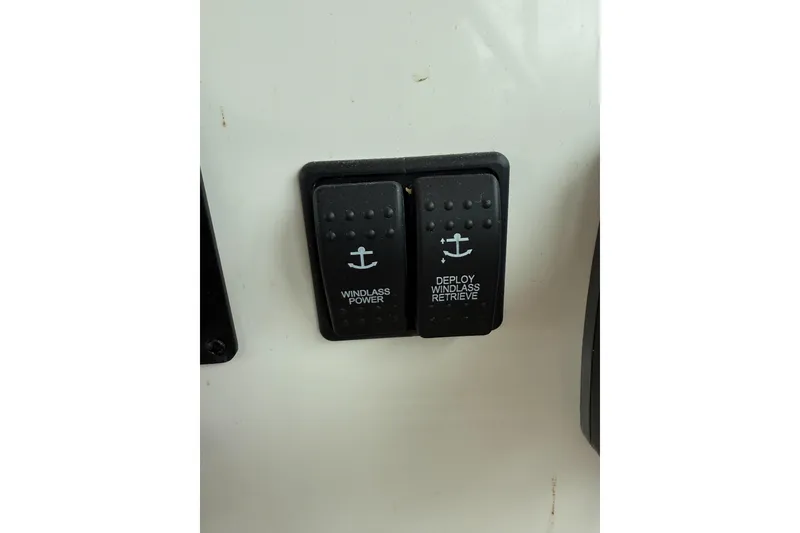 Slide: The Image of Windlass control switches on a 2016 Back Cove 41 boat dashboard. - 26
