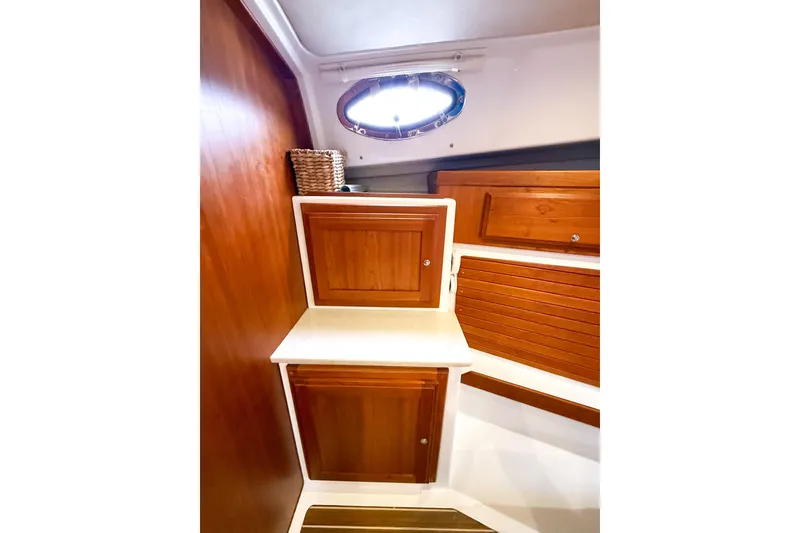 Slide: The Image of 2016 Back Cove 41 yacht interior with wooden cabinets and porthole window. - 29