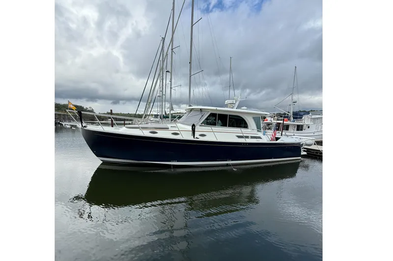 Slide: The Image of 2016 Back Cove 41 yacht docked in a marina under cloudy skies. - 3