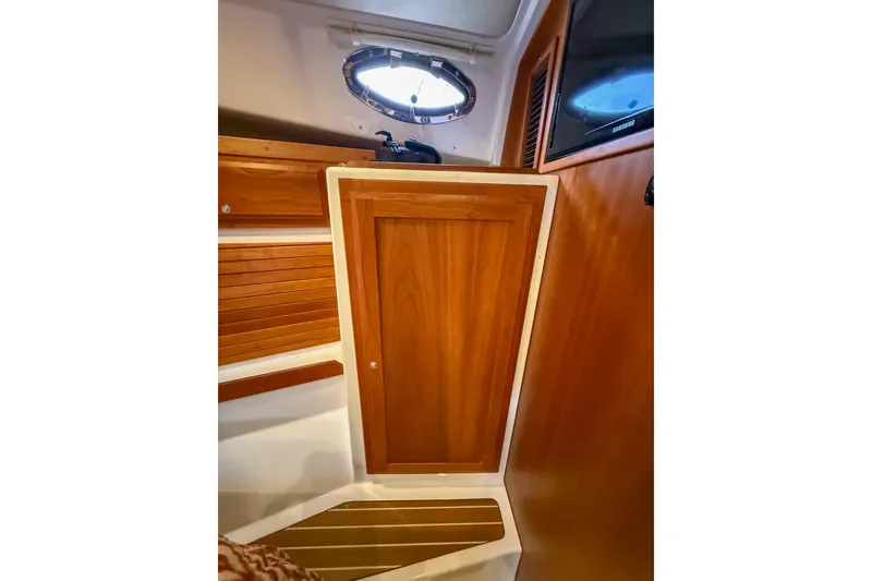 Slide: The Image of Interior of 2016 Back Cove 41 yacht with wooden cabinetry and porthole window. - 30