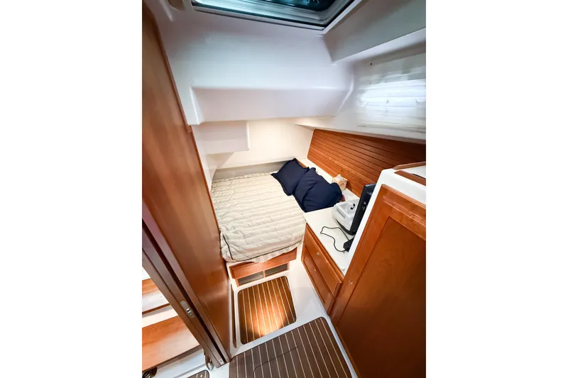 Slide: The Image of 2016 Back Cove 41 yacht cabin with cozy bed, wooden cabinetry, and natural light. - 35