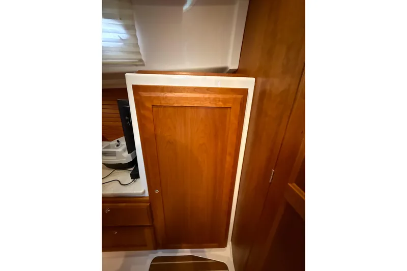 Slide: The Image of Wooden cabinet door inside 2016 Back Cove 41 yacht interior, featuring sleek design and warm tones. - 36