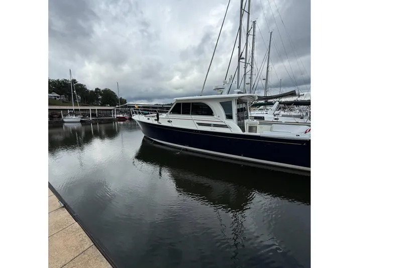 Slide: The Image of 2016 Back Cove 41 yacht docked at a marina under cloudy skies. - 4