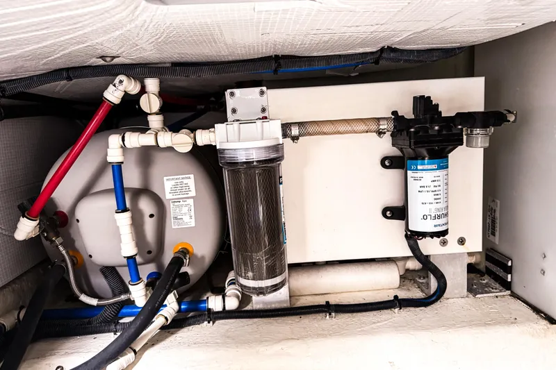 Slide: The Image of Engine room of 2016 Back Cove 41 boat showing plumbing and filtration system. - 47