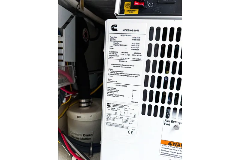 Slide: The Image of Engine compartment of 2016 Back Cove 41 with Cummins Onan marine muffler and emergency stop. - 49