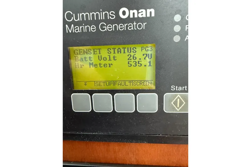 Slide: The Image of Cummins Onan marine generator display showing battery voltage and hour meter on Back Cove 41, 2016. - 50