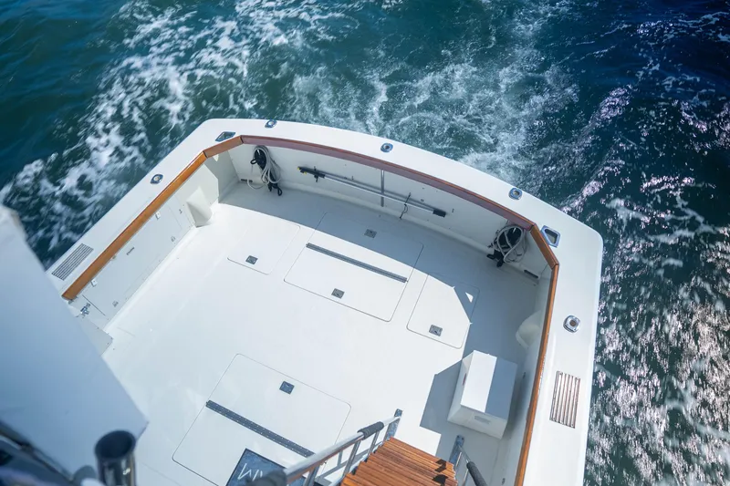 Slide: The Image of 1984 Bertram 35 Convertible boat deck with ocean view, featuring spacious layout and wooden accents. - 11