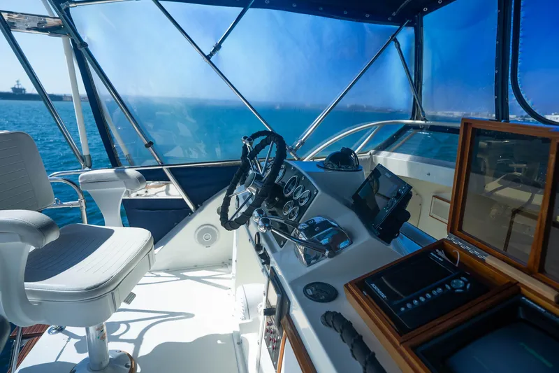 Slide: The Image of Interior view of 1984 Bertram 35 Convertible yacht cockpit with steering wheel and controls. - 12
