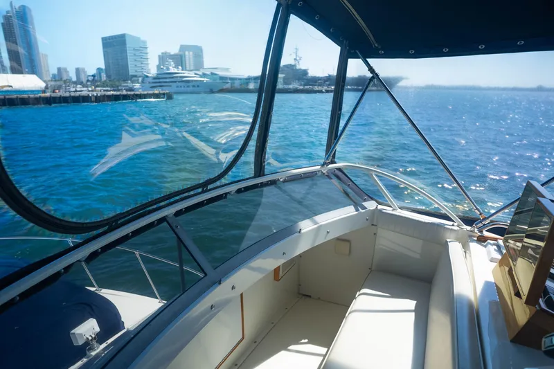 Slide: The Image of Interior view of 1984 Bertram 35 Convertible yacht with city skyline in background. - 16