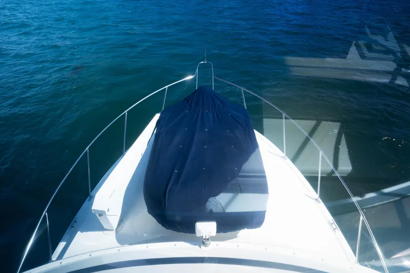 Slide: The Image of 1984 Bertram 35 Convertible boat bow view on calm blue water. - 17