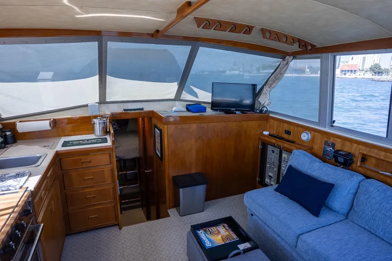 Slide: The Image of Interior of a 1984 Bertram 35 Convertible yacht with cozy seating and ocean view. - 18