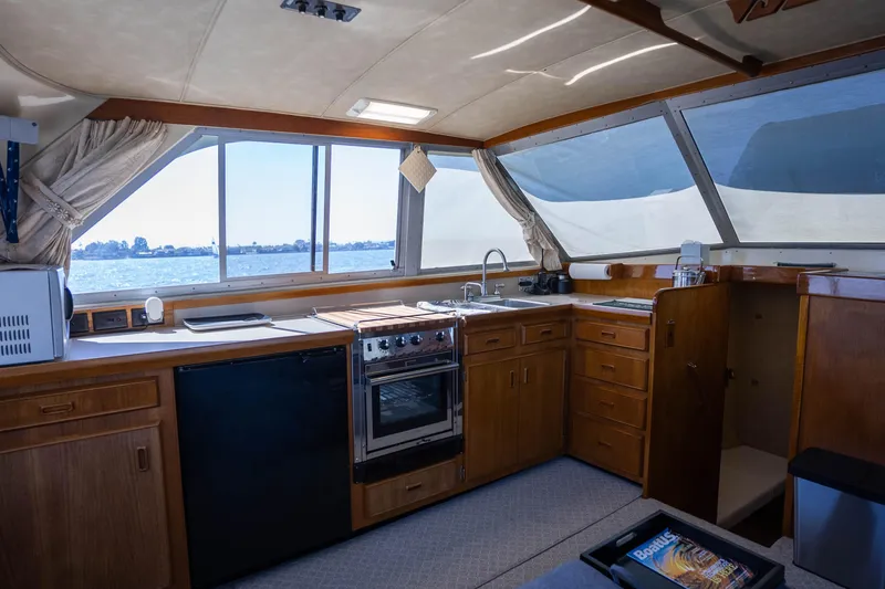 Slide: The Image of Interior of 1984 Bertram 35 Convertible yacht with kitchen and ocean view. - 19