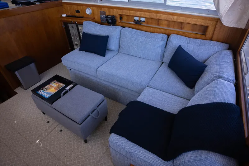 Slide: The Image of Interior of 1984 Bertram 35 Convertible with cozy gray sofa and navy cushions. - 20