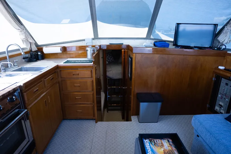 Slide: The Image of Interior of 1984 Bertram 35 Convertible yacht with kitchen and seating area. - 24