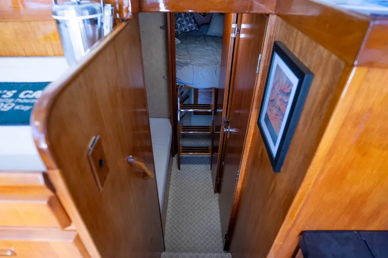 Slide: The Image of Interior of 1984 Bertram 35 Convertible yacht with wooden finishes and cozy sleeping area. - 25