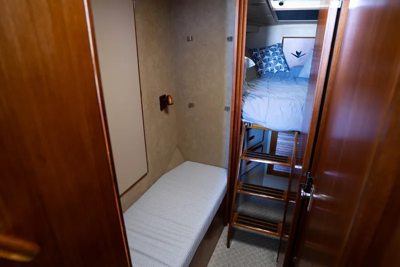 Slide: The Image of 1984 Bertram 35 Convertible cabin interior with bunk beds and wooden ladder. - 26