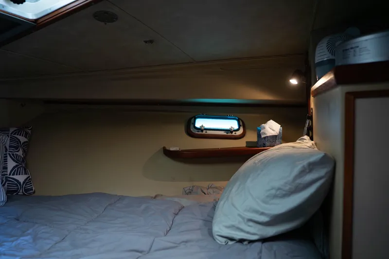 Slide: The Image of Cozy cabin interior of 1984 Bertram 35 Convertible with bed and porthole. - 29