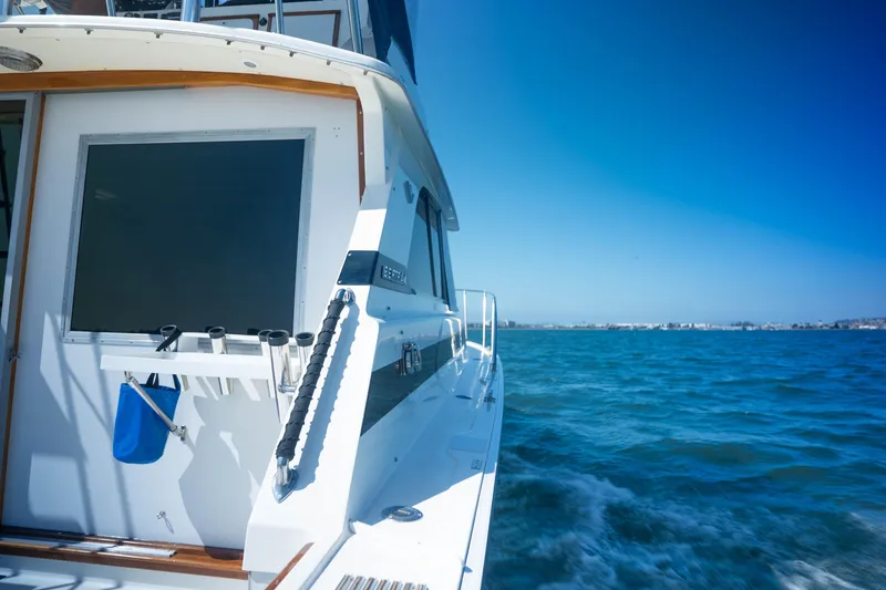 Slide: The Image of 1984 Bertram 35 Convertible yacht cruising on open blue water under clear skies. - 5