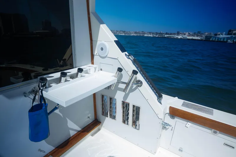 Slide: The Image of 1984 Bertram 35 Convertible boat deck with fishing rod holders, ocean view. - 9