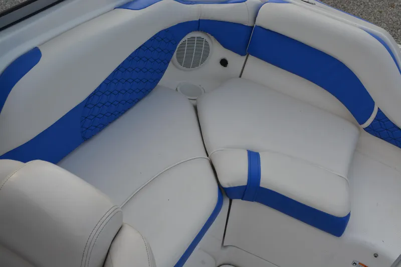 Slide: The Image of 2011 Yamaha AR210 boat interior with blue and white cushioned seating. - 10