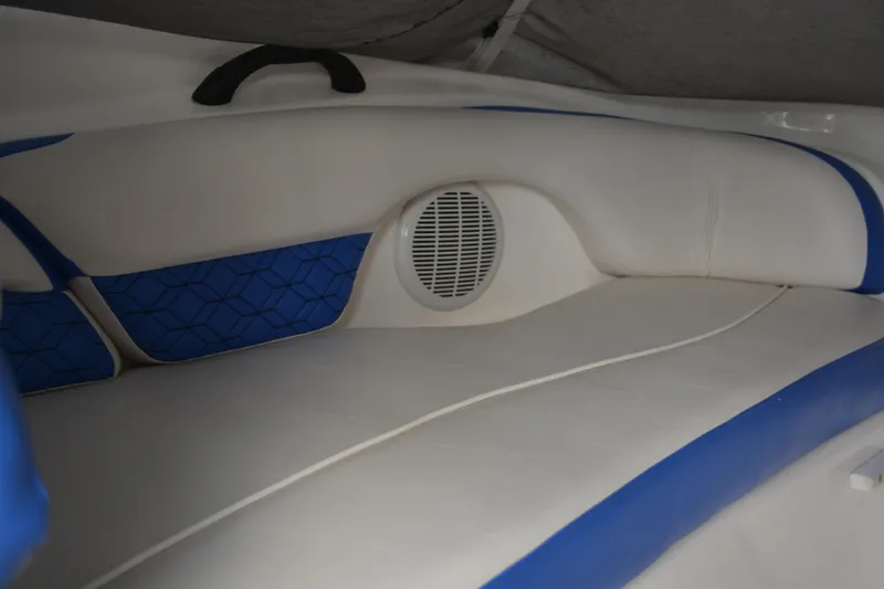 Slide: The Image of 2011 Yamaha AR210 boat interior with blue and white seating and speaker. - 11