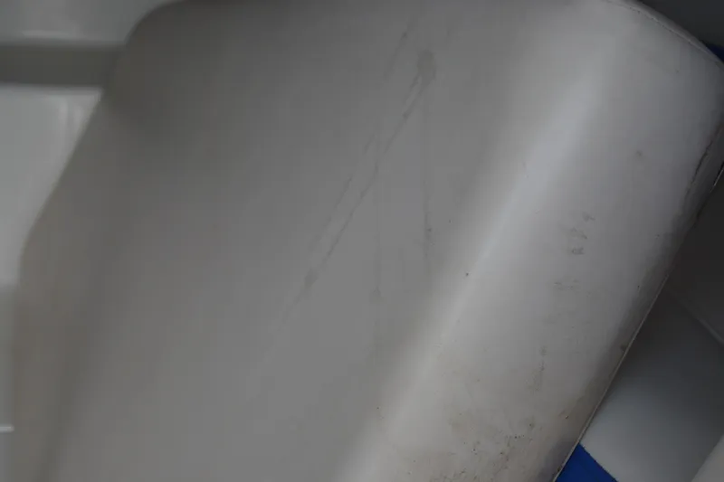 Slide: The Image of Close-up of a 2011 Yamaha AR210 boat seat with visible wear. - 12