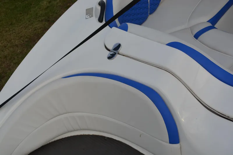 Slide: The Image of 2011 Yamaha AR210 boat interior with white and blue seating. - 14