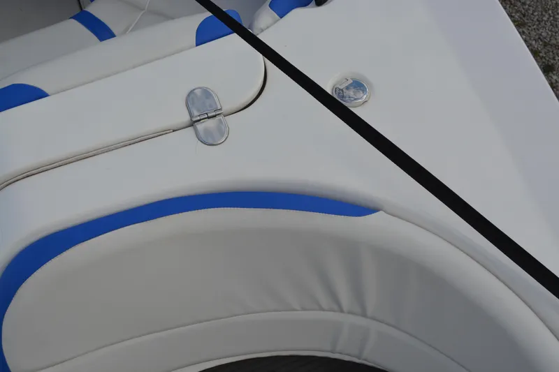 Slide: The Image of 2011 Yamaha AR210 boat interior with white and blue seating detail. - 15