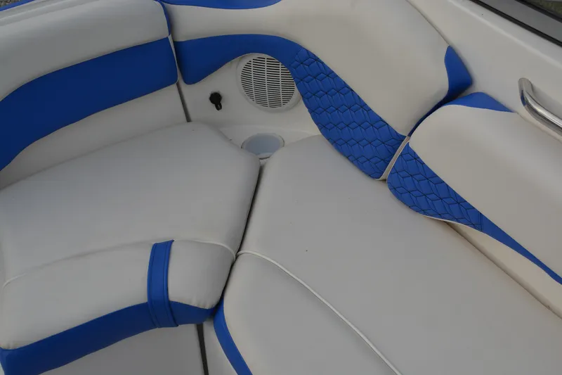 Slide: The Image of 2011 Yamaha AR210 boat interior with blue and white cushioned seating. - 17